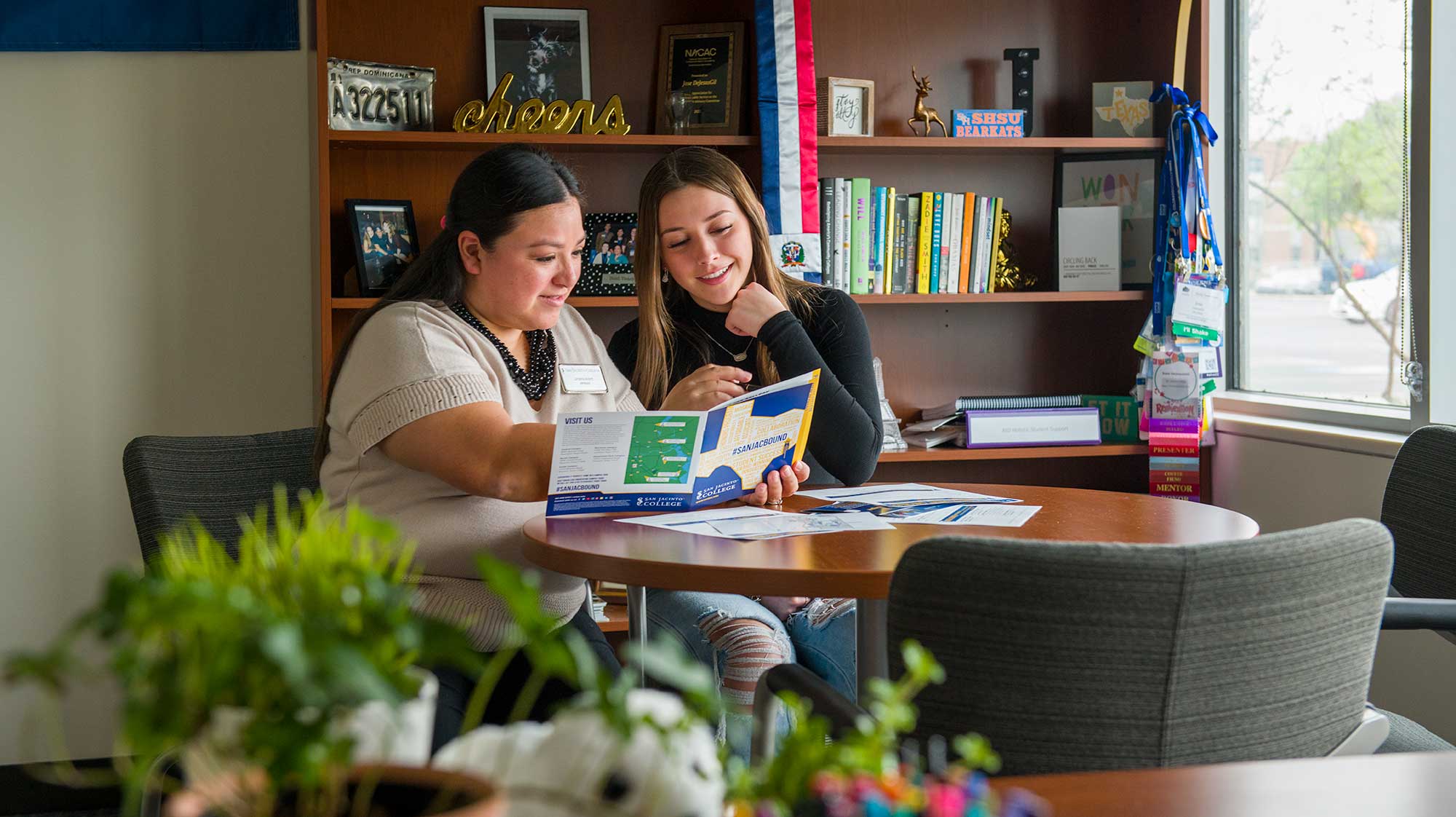 two women looking at booklet