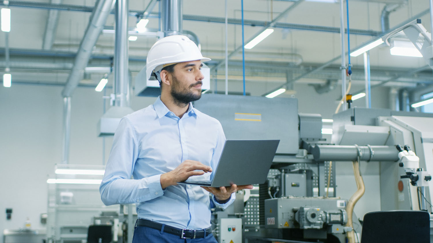 Advanced Manufacturing Student in hard hat with laptop