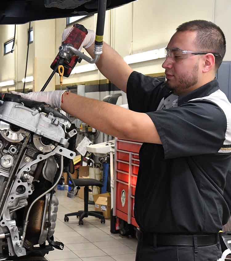 toyota tten student working on a car part