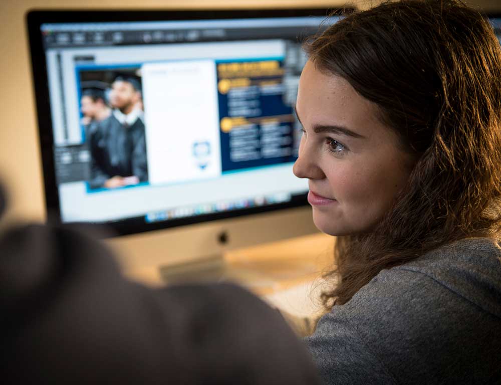 Web Design student in front of computer monitor