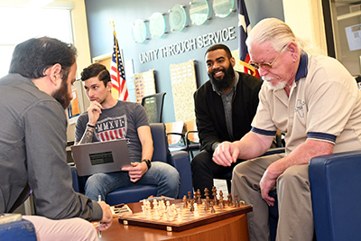Veteran students playing chess in the South Campus veteran center